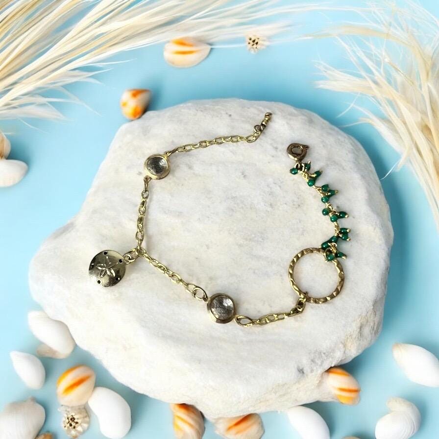 Gold Charm Bracelet with Sand Dollar & Emerald Cluster Accents