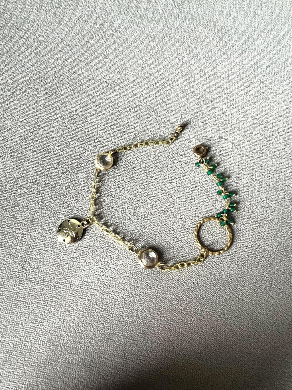 Gold Charm Bracelet with Sand Dollar & Emerald Cluster Accents