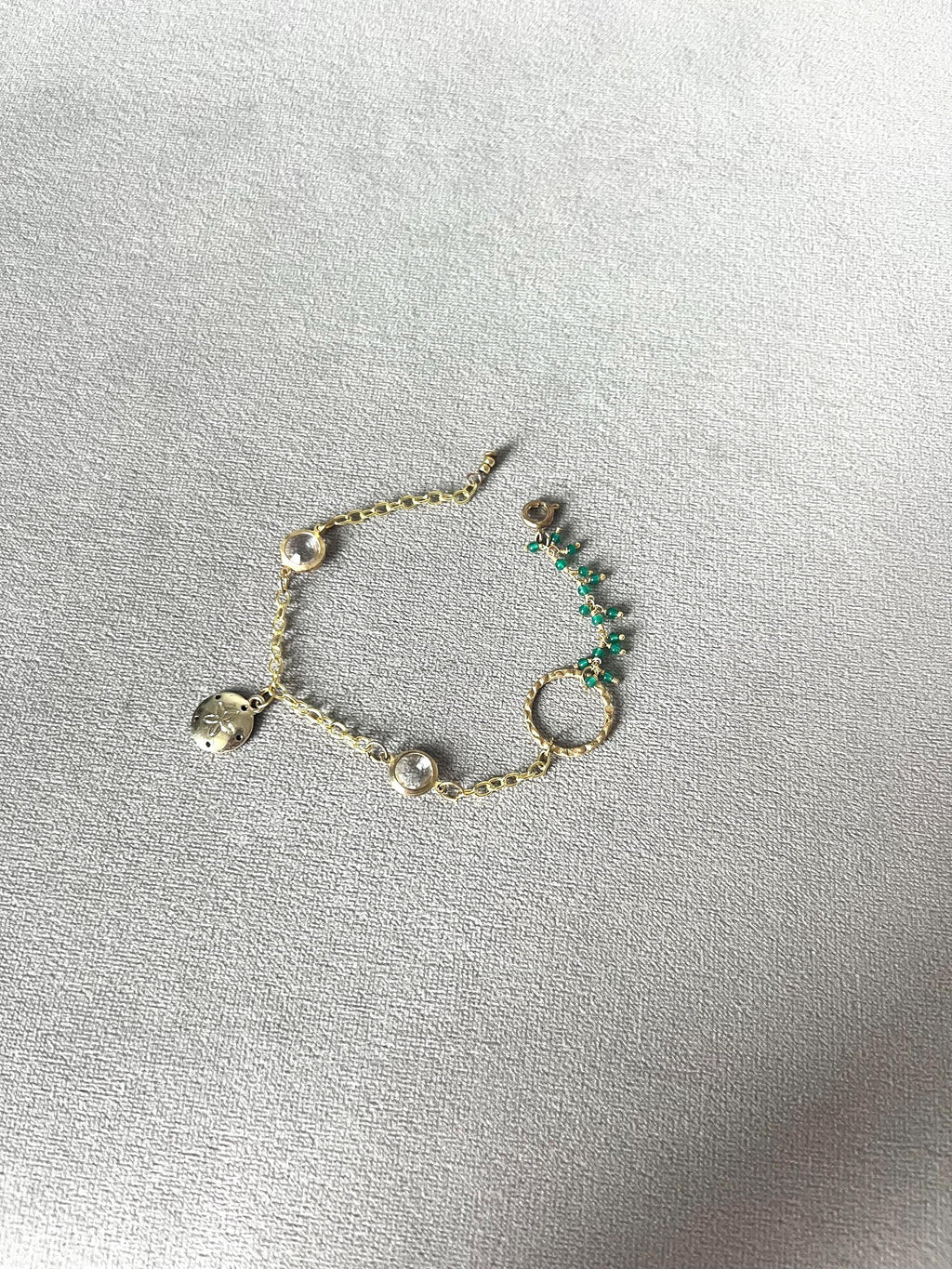 Gold Charm Bracelet with Sand Dollar & Emerald Cluster Accents