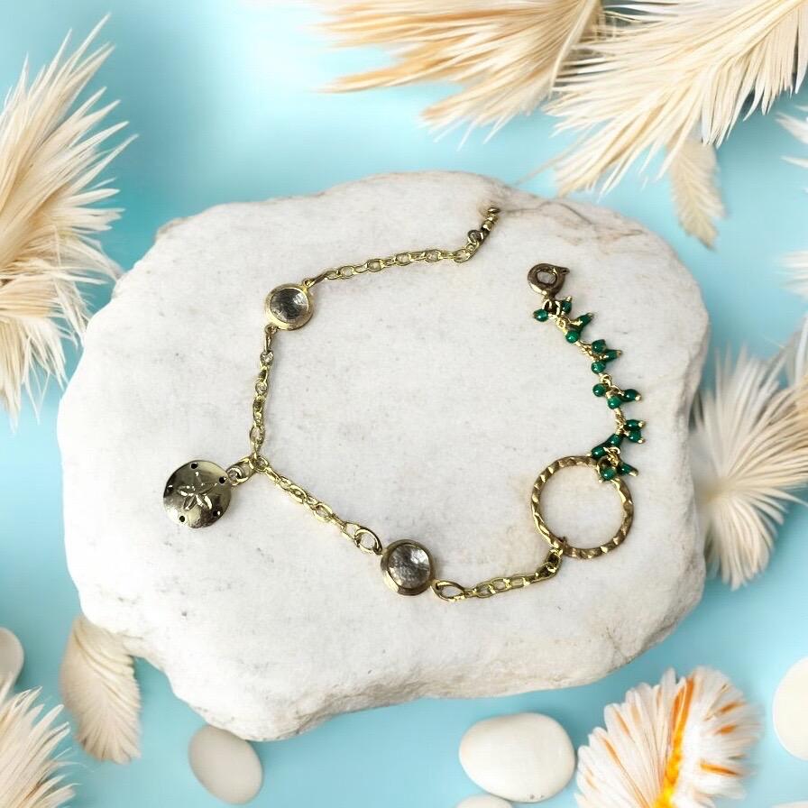 Gold Charm Bracelet with Sand Dollar & Emerald Cluster Accents